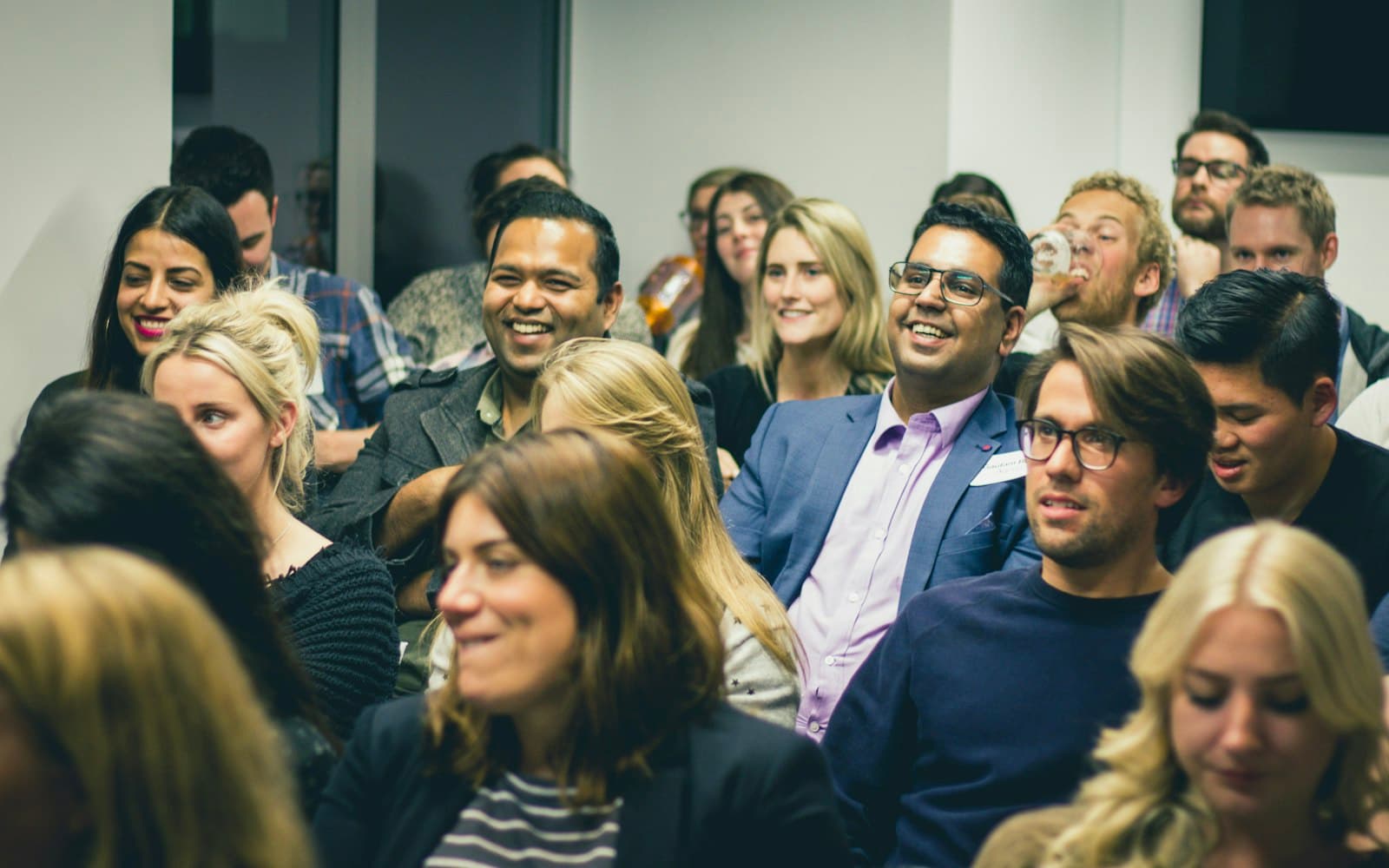 Members smiling and talking at a networking event
